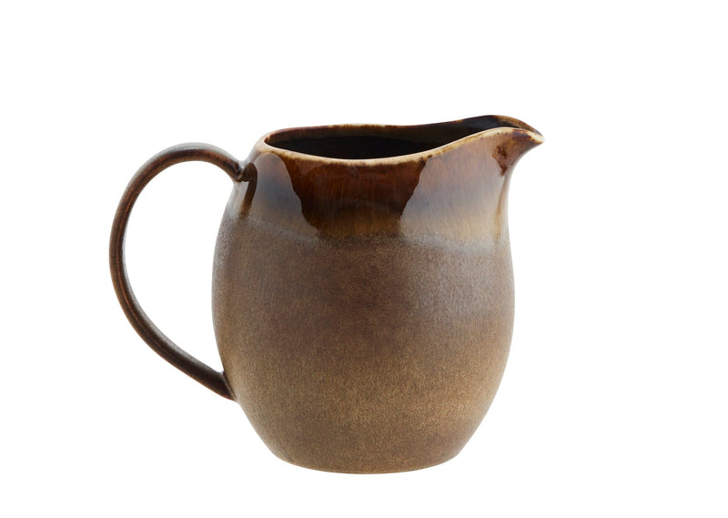 Brown ceramic pitcher on a white background