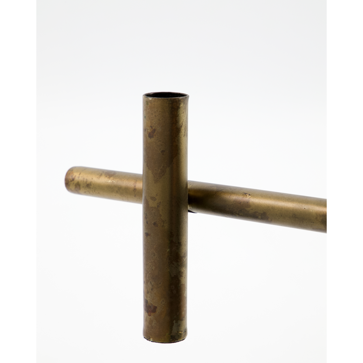 close-up of antique brass candle holder showing weathered patina and metal texture