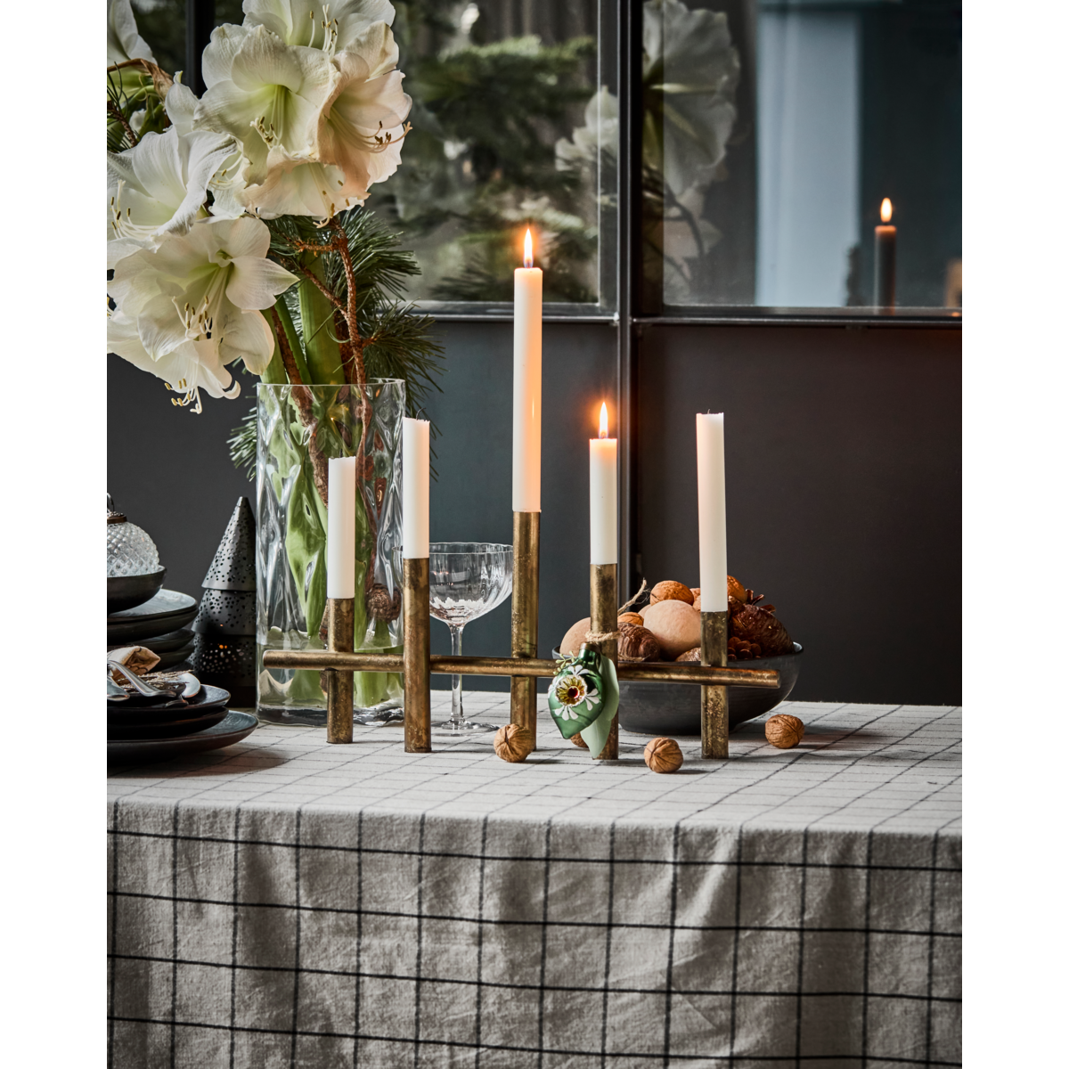 antique brass candle holder styled on festive dining table with tall taper candles
