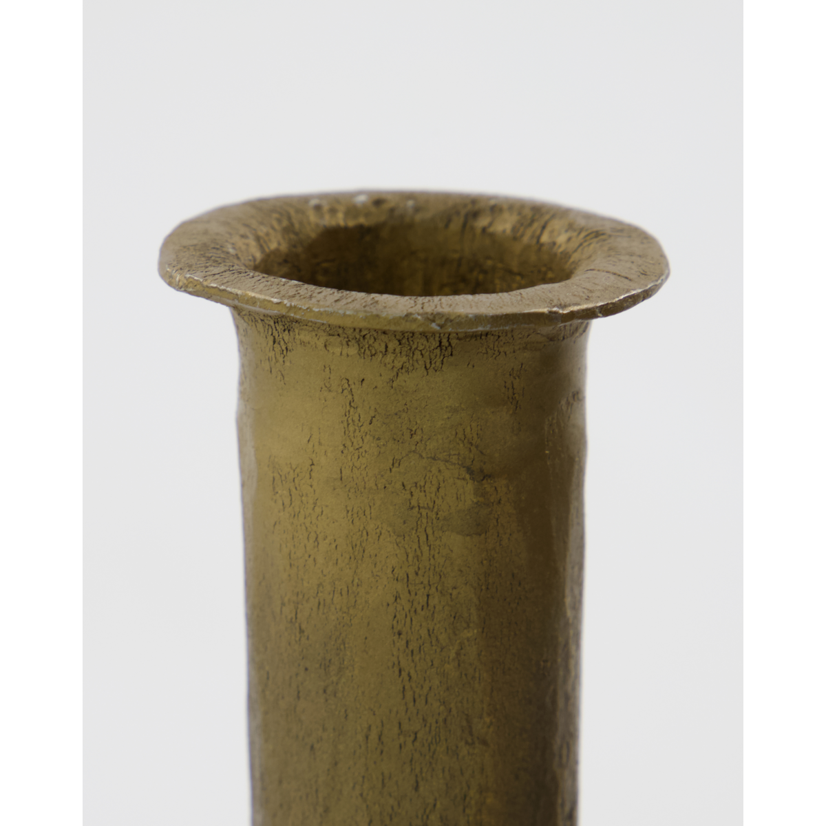 close-up of handcrafted textured rim on medium antique gold candle holder