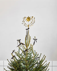 House Doctor Clip gold star topper on a Christmas tree decorated with black bows