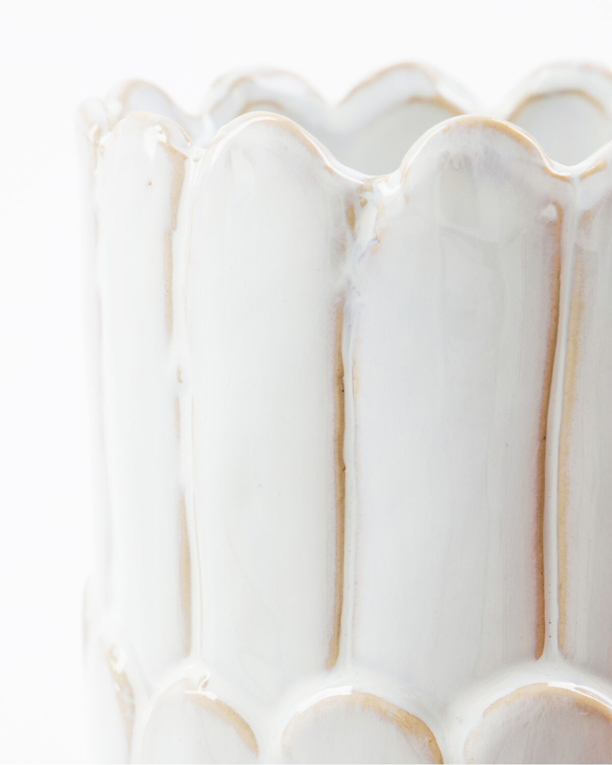 Close-up of the scalloped rim and glossy off-white glaze on the House Doctor Ezra vase