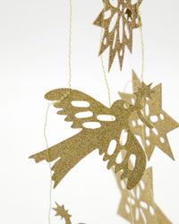 Close-up of a gold glitter paper bird on the House Doctor Figure garland
