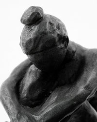 Close-up of the bowed head and top knot on the House Doctor Forms figure sculpture
