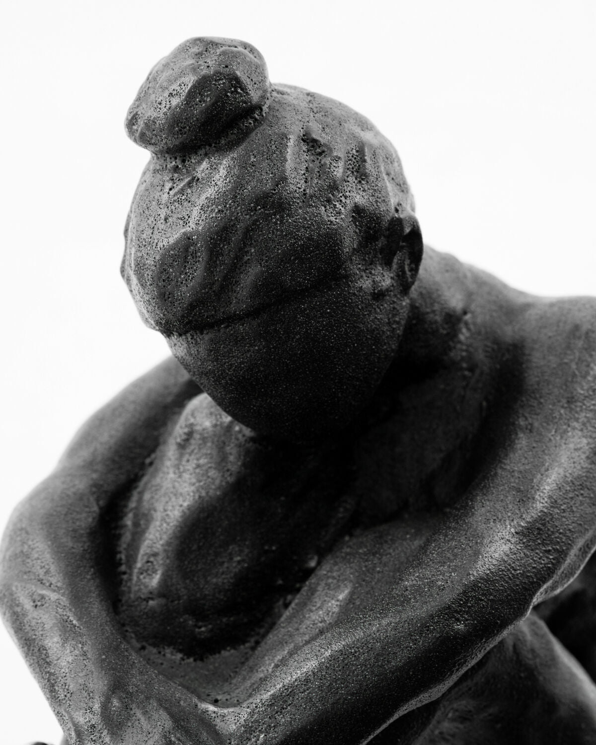 Close-up of the bowed head and top knot on the House Doctor Forms figure sculpture