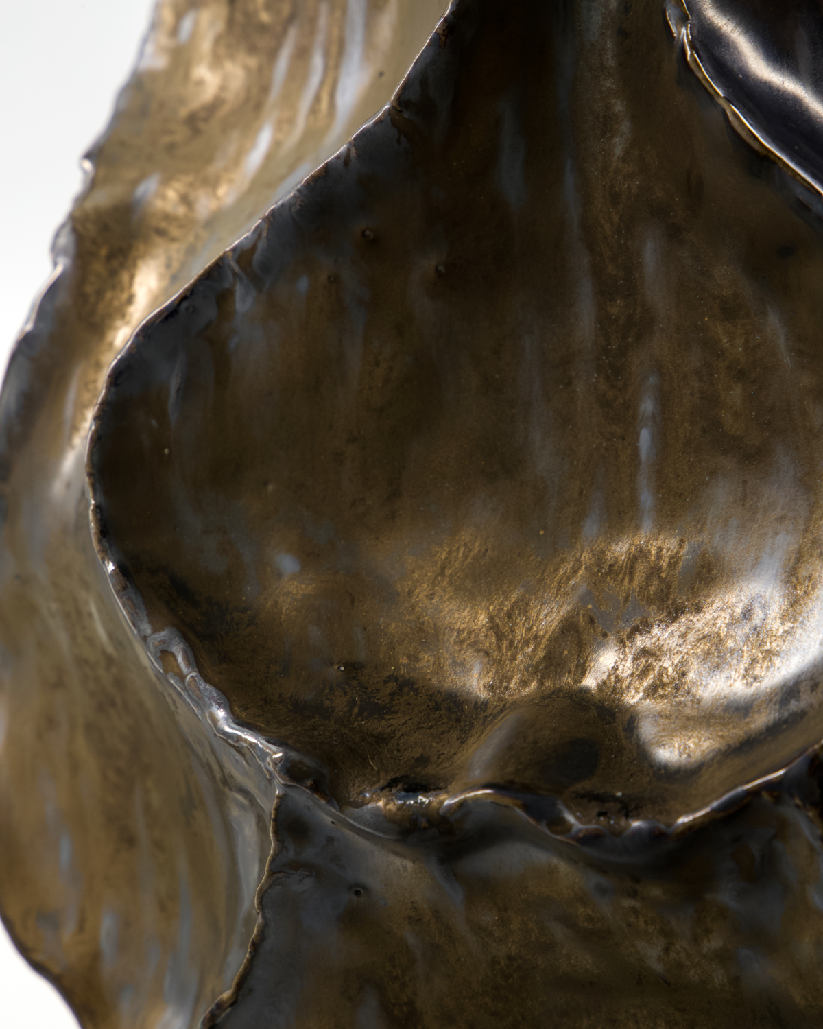 Close-up of the antique metallic glaze on the House Doctor Waves vase with bronze, pewter and gunmetal tones across the handmade stoneware surface