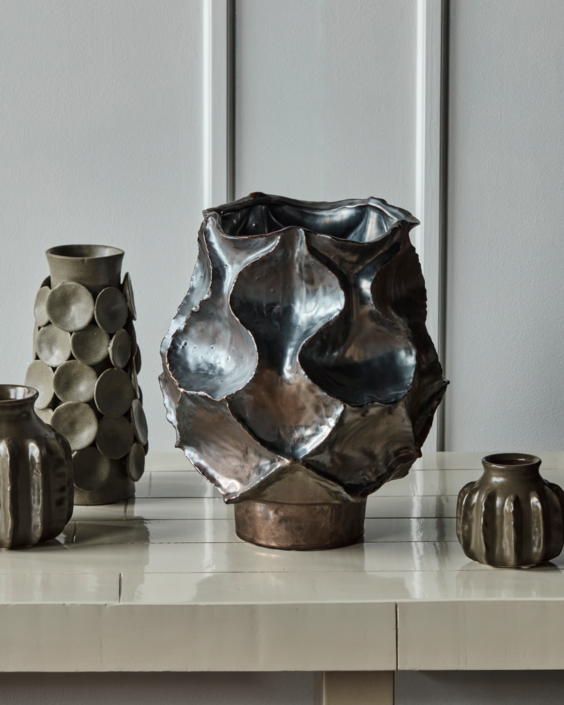 House Doctor Waves large statement vase styled alongside the Dot vase and smaller handmade stoneware ceramics on a pale console, a sculptural tonal grouping for modern interiors