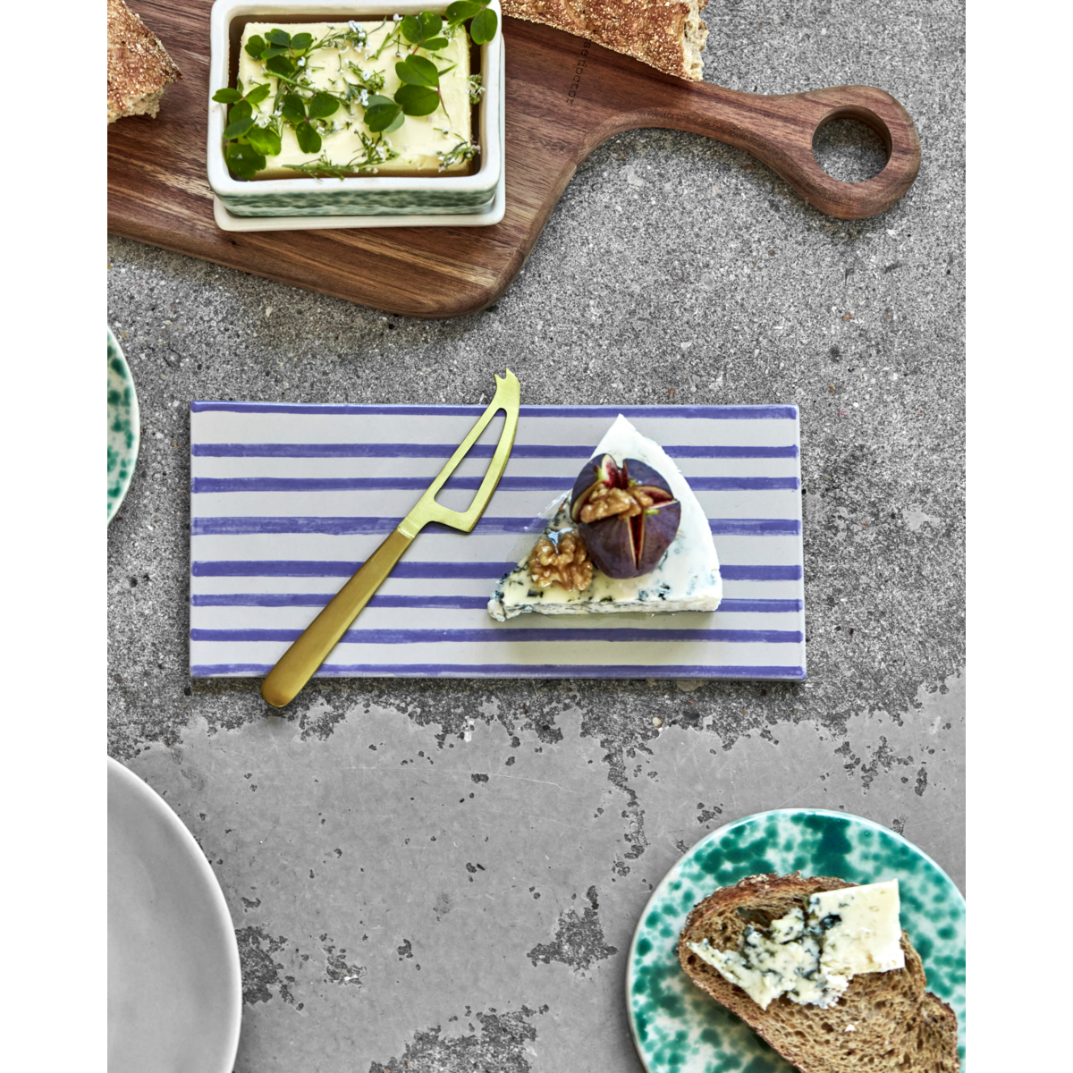 Blue stripe ceramic board styled with cheese and fig
