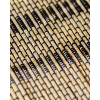 Close-up of black and natural woven bamboo table runner by House Doctor
