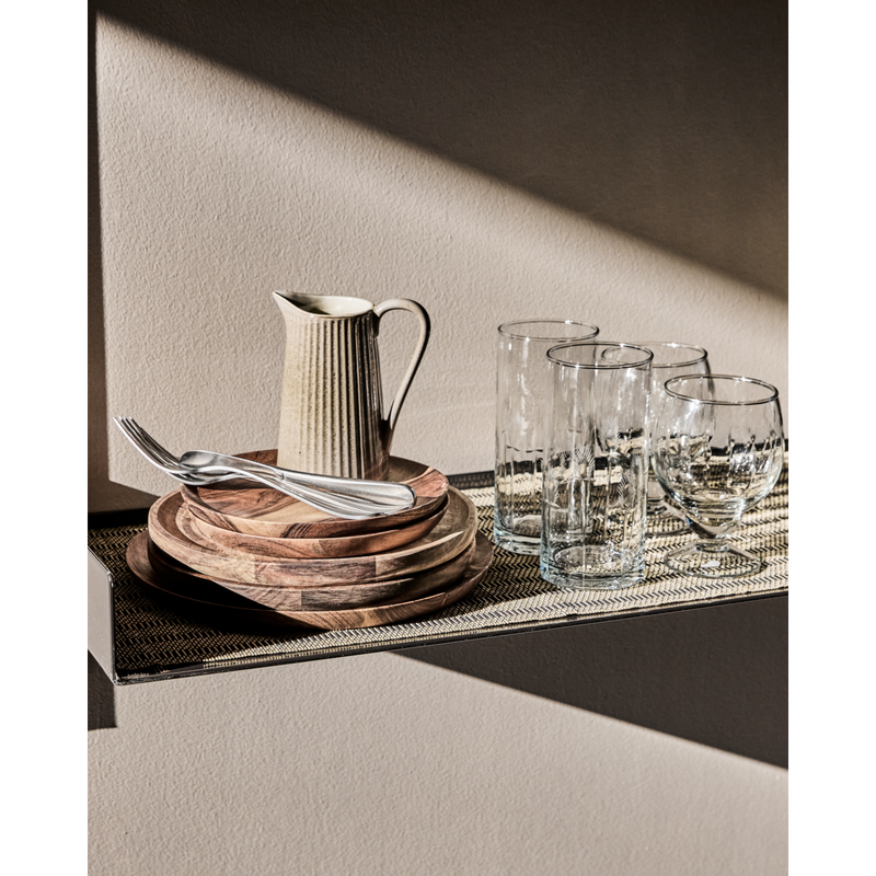 Table runner styled with wooden tableware and glassware on shelf

