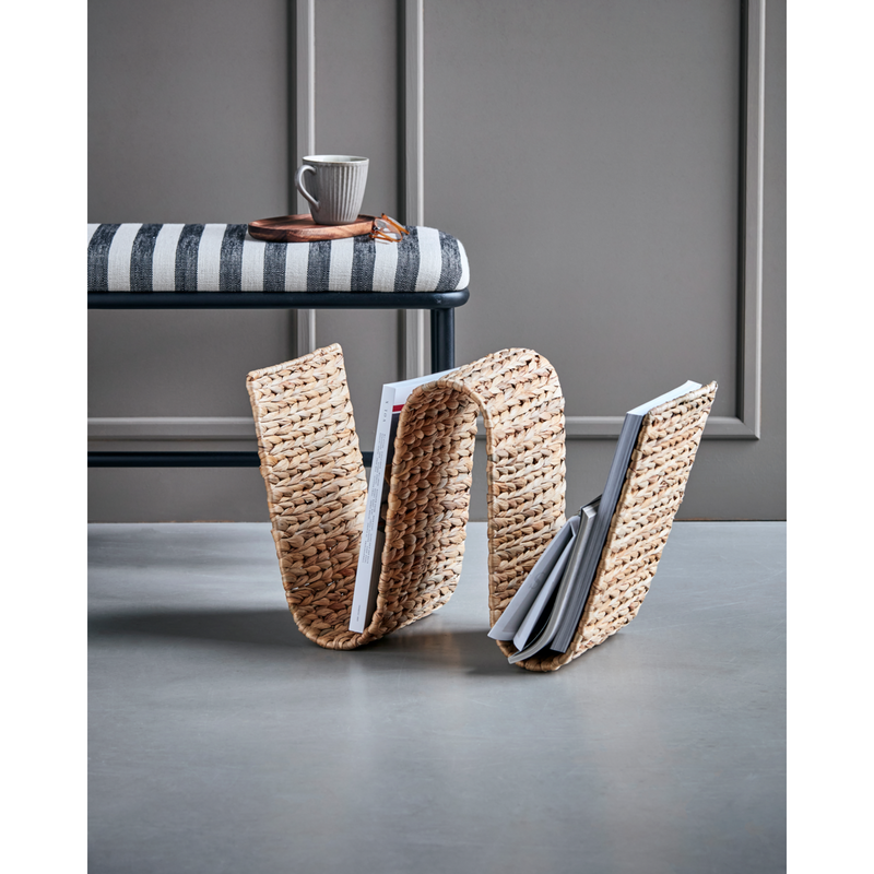 house doctor magazine rack styled under bench in modern interior

