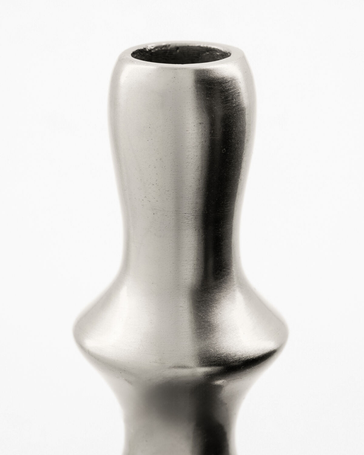 Close-up of the House Doctor Reese candle stand's neck and shoulder, showing the polished silver finish