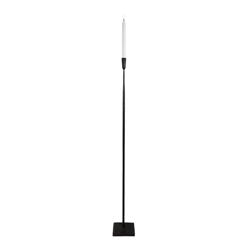 Ina tall black iron floor candle holder by Olsson & Jensen with a taper candle