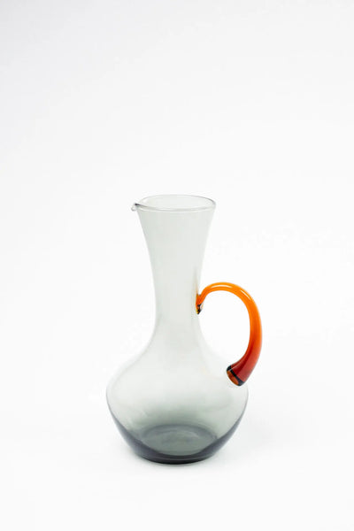 Isidora glass jug by Olsson & Jensen in smoky grey glass with an amber handle, amber grey colourway