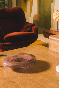 Jade glass bowl by Olsson & Jensen on a wooden floor in a living room