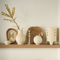 Juna candlestick styled on a wooden shelf with cream vases and dried branches