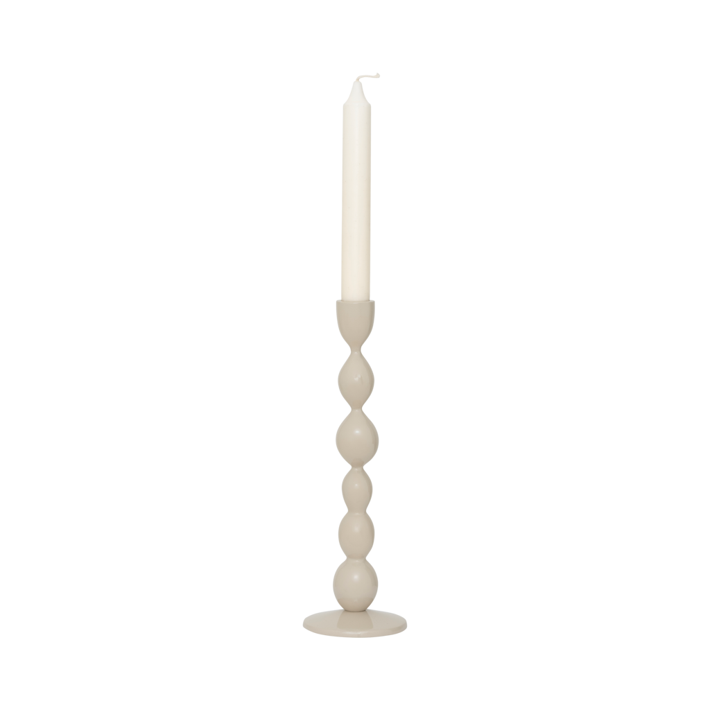 Juna candle holder with an ivory dinner candle