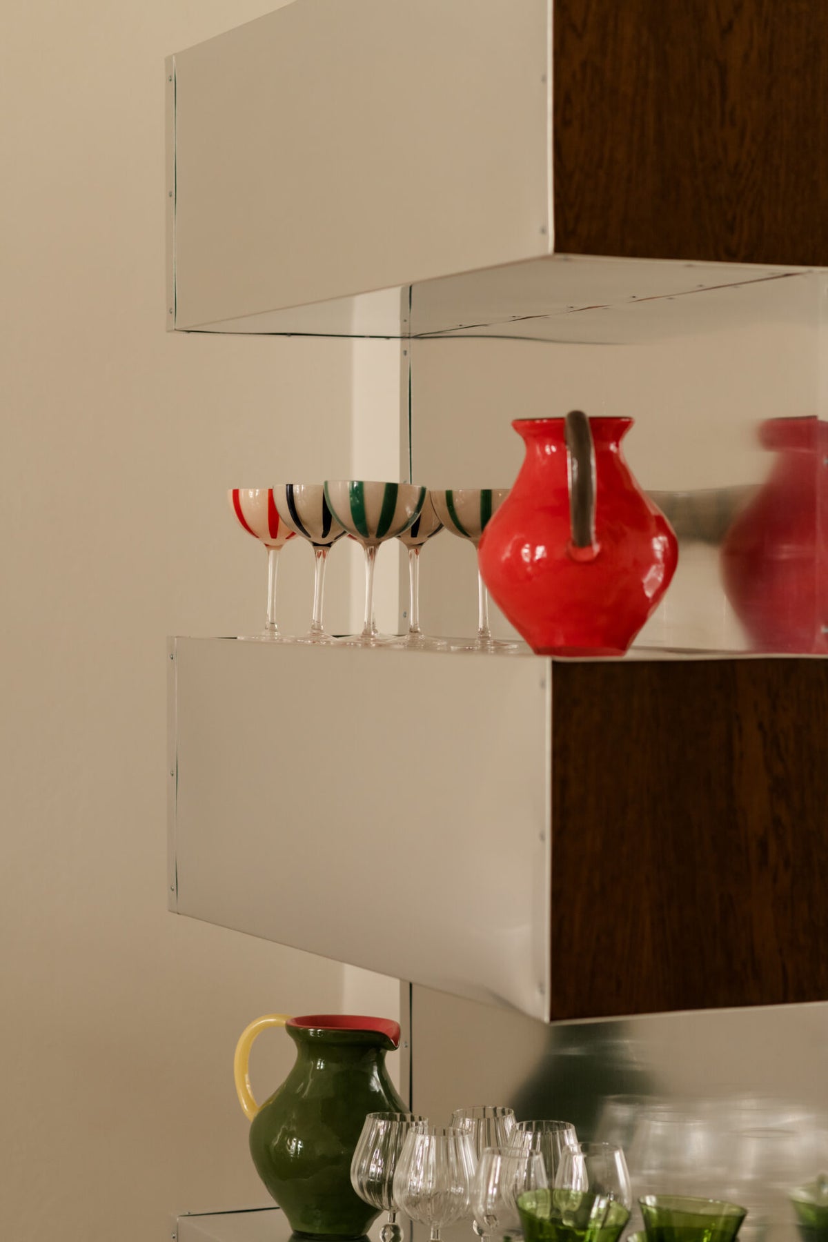 Kiko coral and green jugs by Olsson & Jensen on open shelving