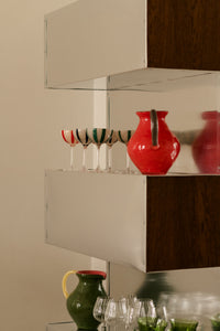 Kiko green and coral jugs by Olsson & Jensen on open shelving