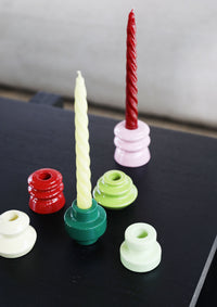 colourful &klevering stoneware candle holders on a black coffee table with twist tapers
