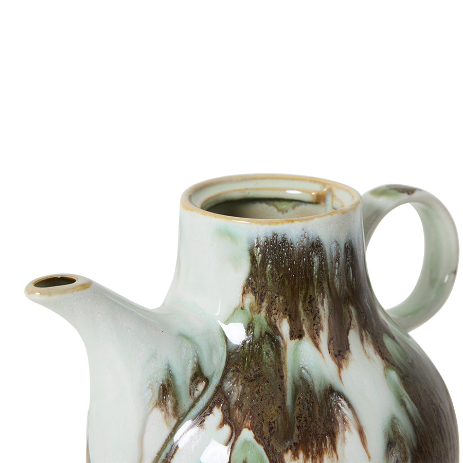 Ceramic teapot with brown and white glaze on a white background
