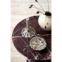 View from above of the Marel burgundy marble table top with a candlestick, dish and vase