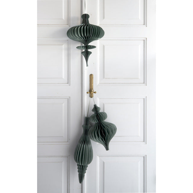 Forest green Passia paper ornaments hanging on a white panelled door