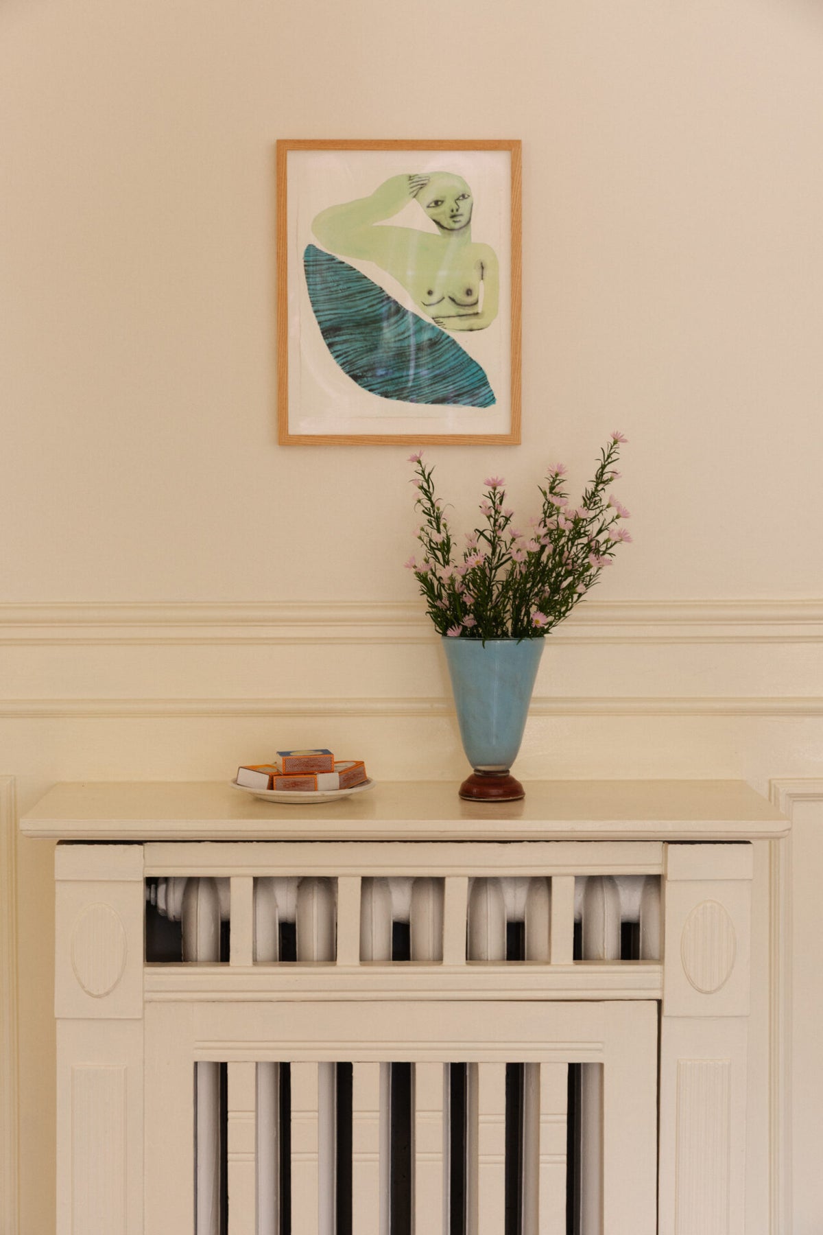 Lolli light blue vase by Olsson & Jensen with dried flowers on a white cabinet
