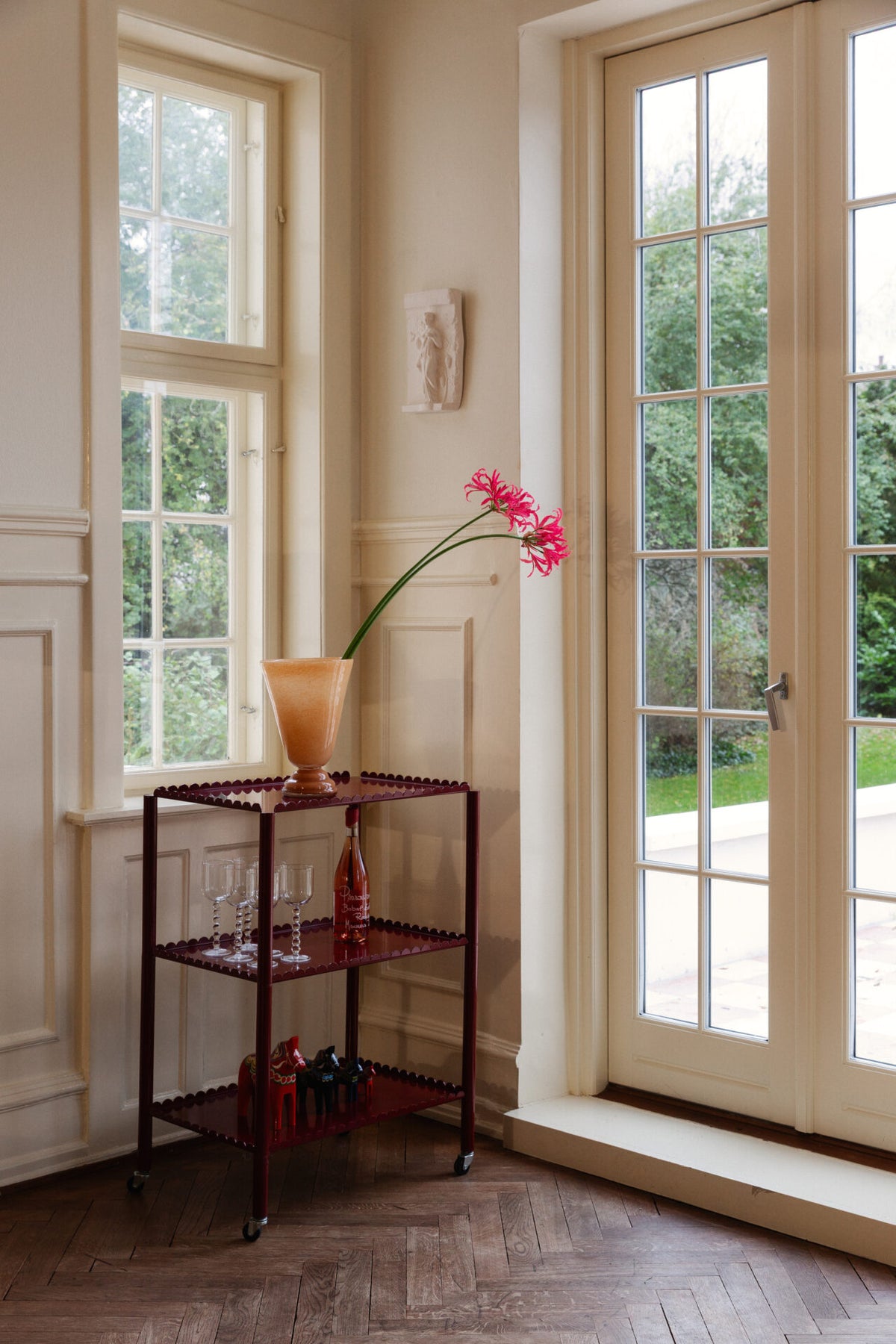 Lolli peach vase by Olsson & Jensen with a pink flower by a window
