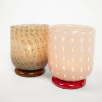 Lolo pink glass tealight holder by Olsson & Jensen with a lit tealight