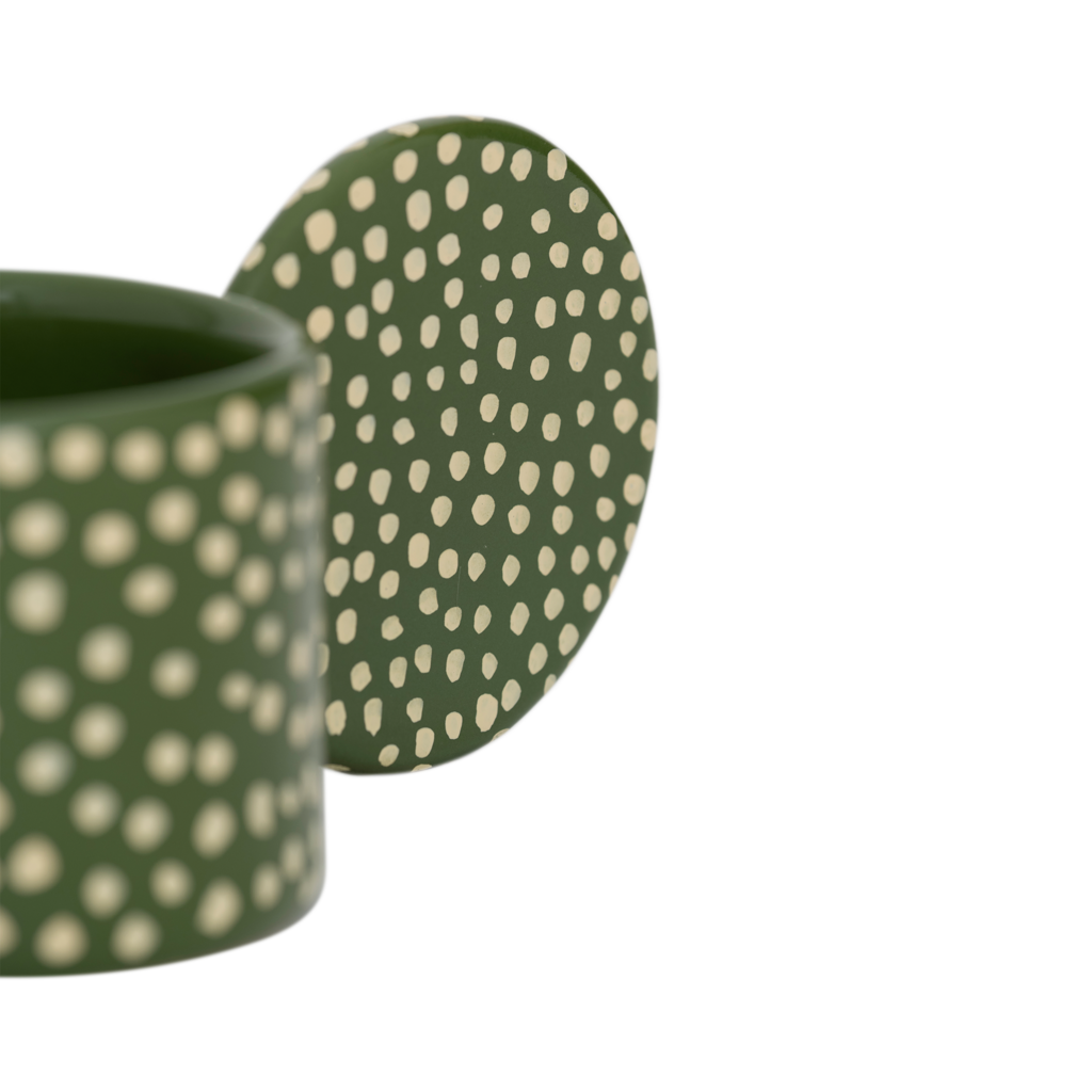 Close-up of the Lucan tealight holder's round handle and cream dots