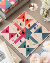 Open Ludo board in play with colourful pieces