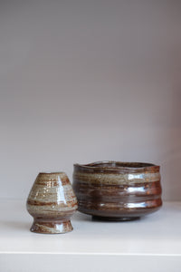 close up of bark matcha bowl showing natural glaze streaks and speckles
