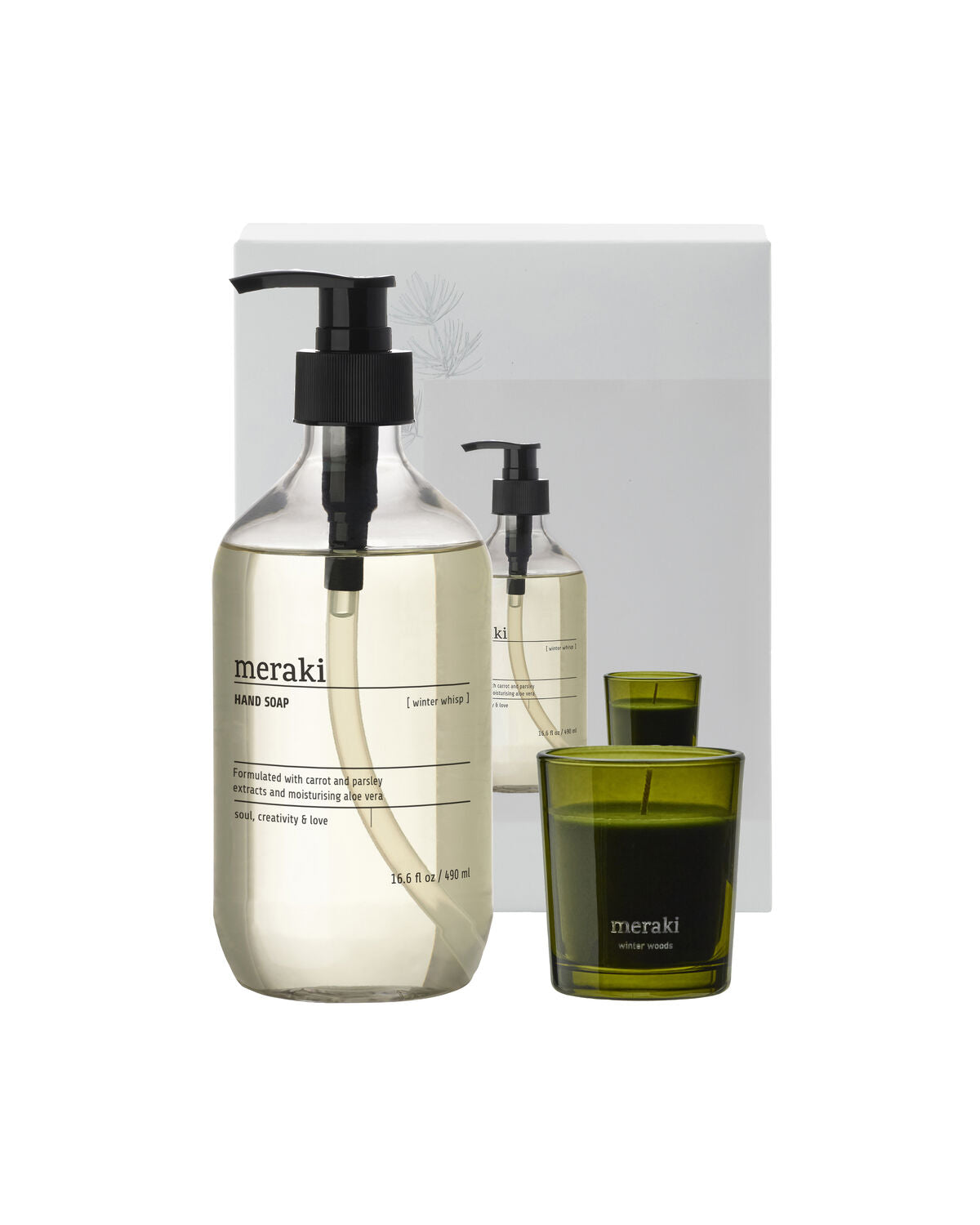 Meraki Winter Whisp hand soap pump bottle and Winter Woods scented candle in green glass beside the box