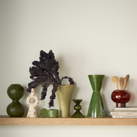 Urban Nature Culture green vases and candle holders on a wooden shelf