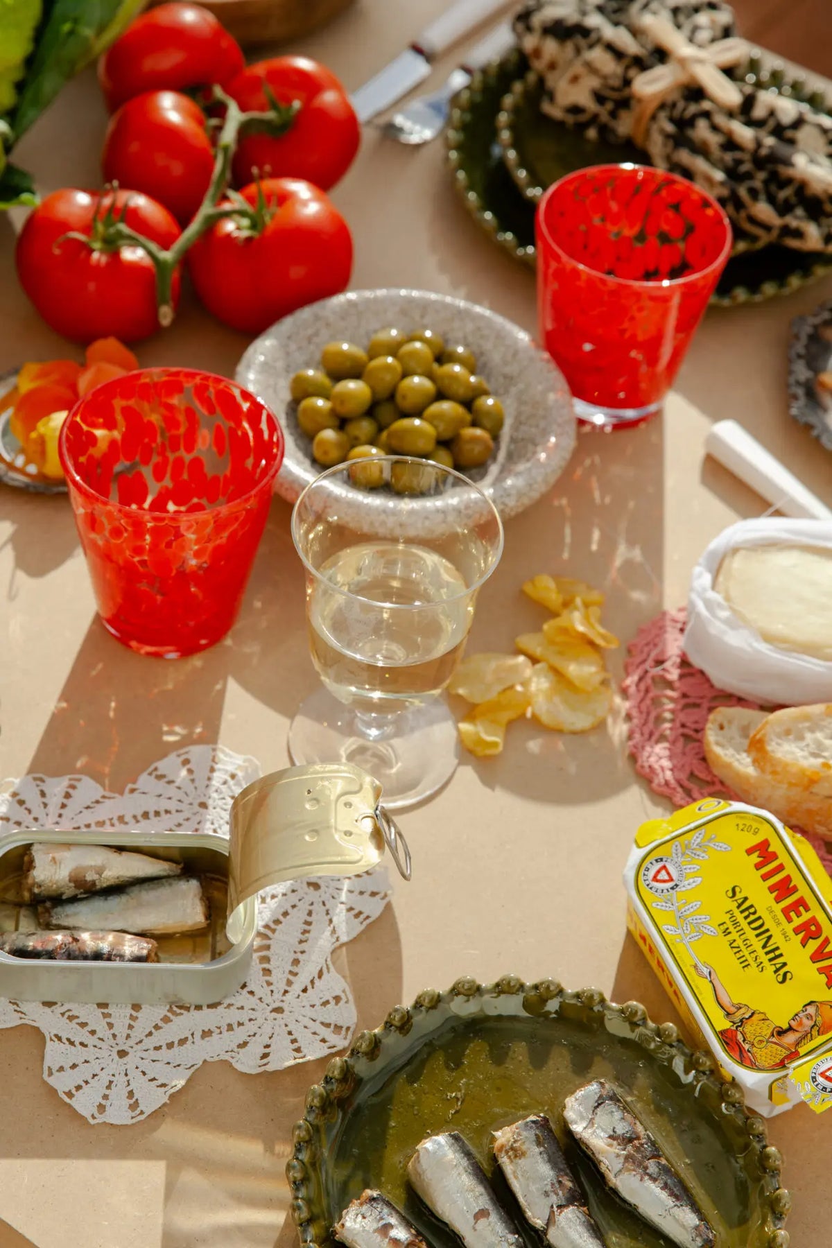 Milano red glass by Olsson & Jensen on a summer table with tomatoes, olives and tapas