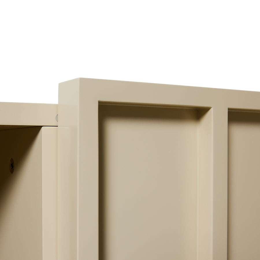 Close-up of a beige cabinet corner with a white background