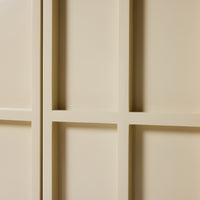 Close-up of a beige paneled wall with geometric patterns