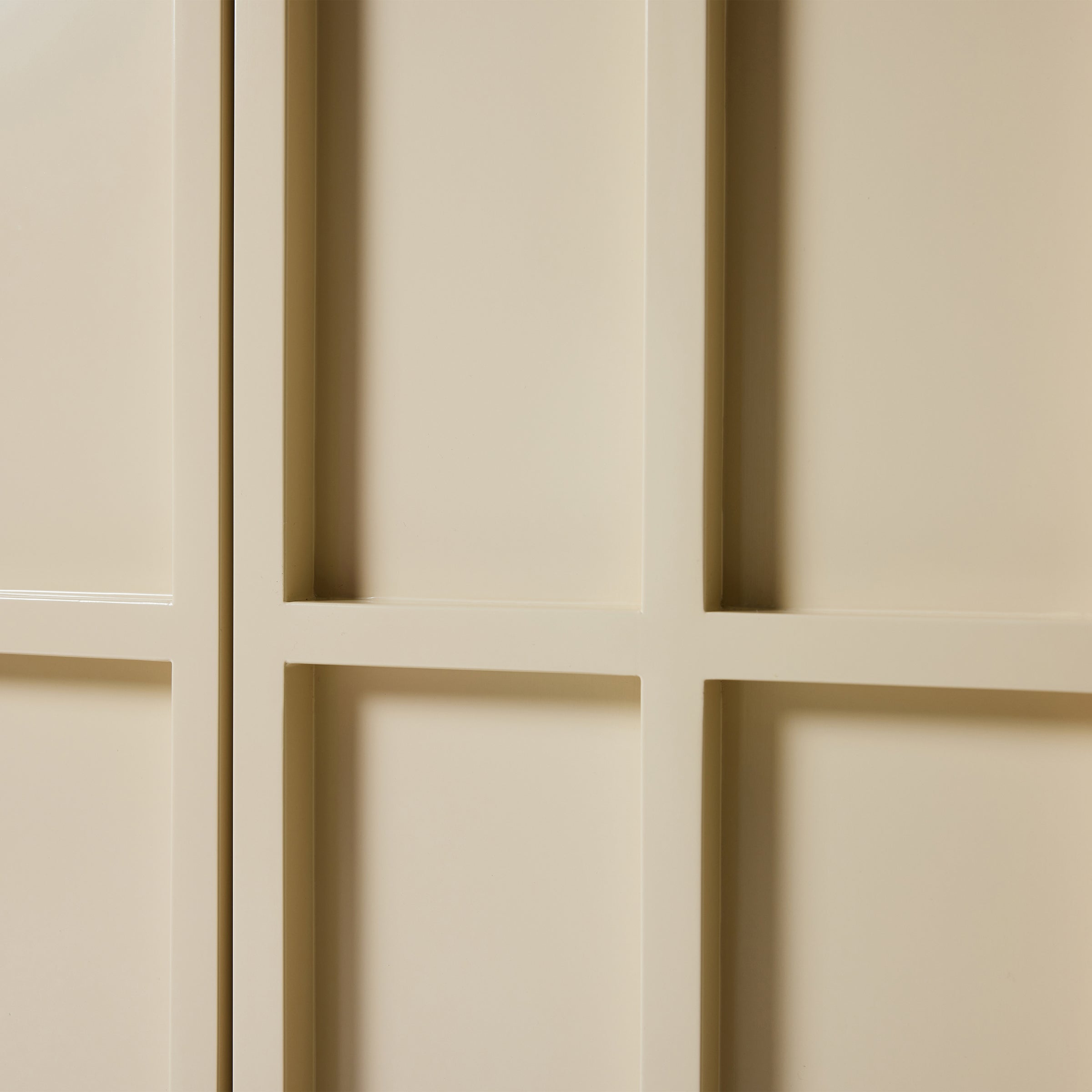 Close-up of a beige paneled wall with geometric patterns