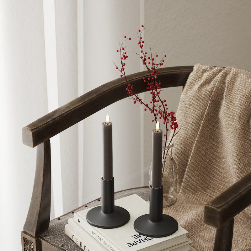 Mixed-height mocha LED dinner candles on a white table with flowers and remote, showing how easily they style together.
