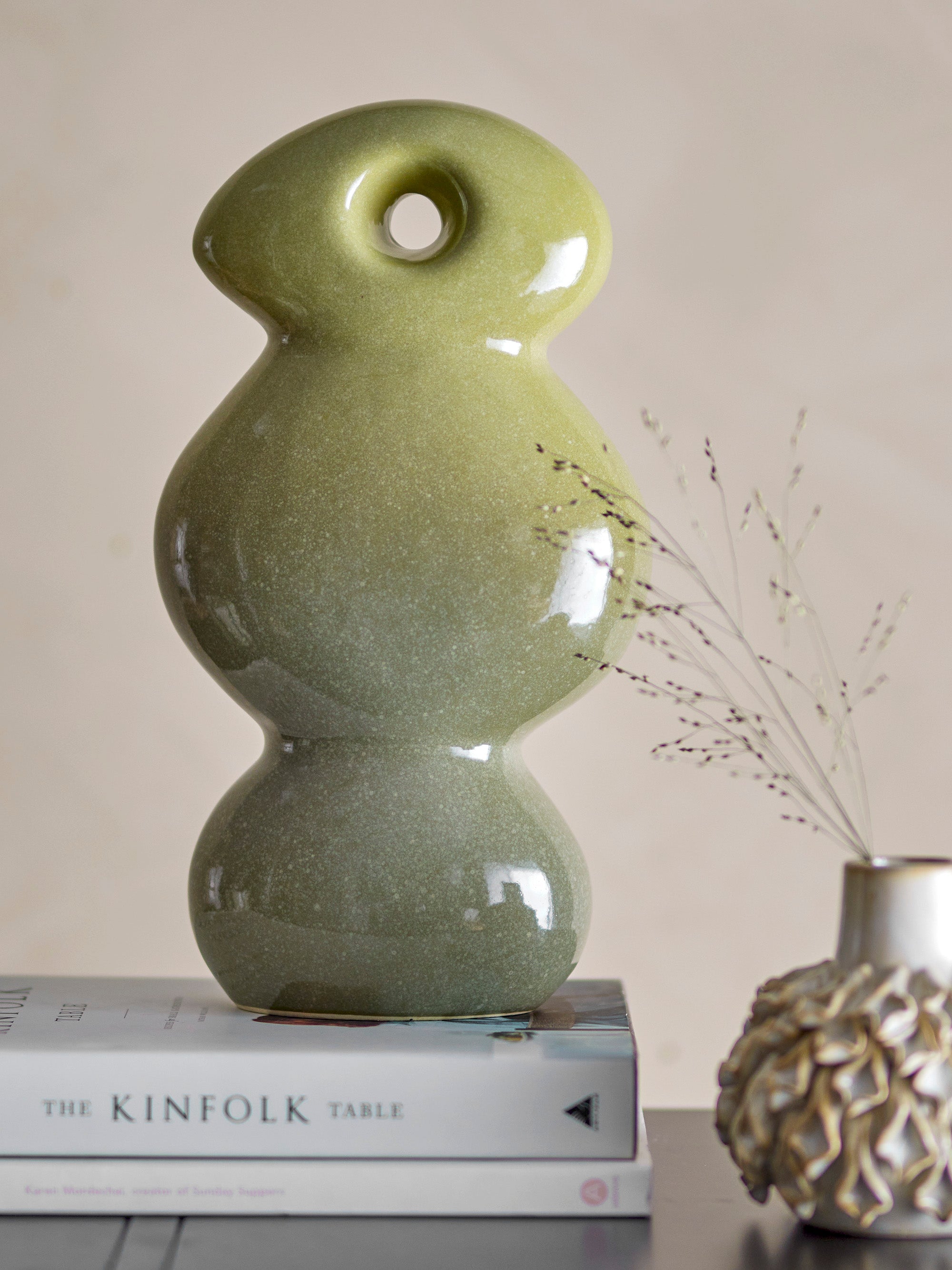 Close-up of the Kaui decorative sculpture showing gradient green glaze