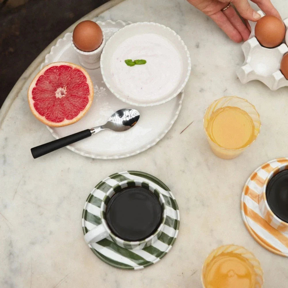 Monica striped cups and saucers by Olsson & Jensen on a breakfast table