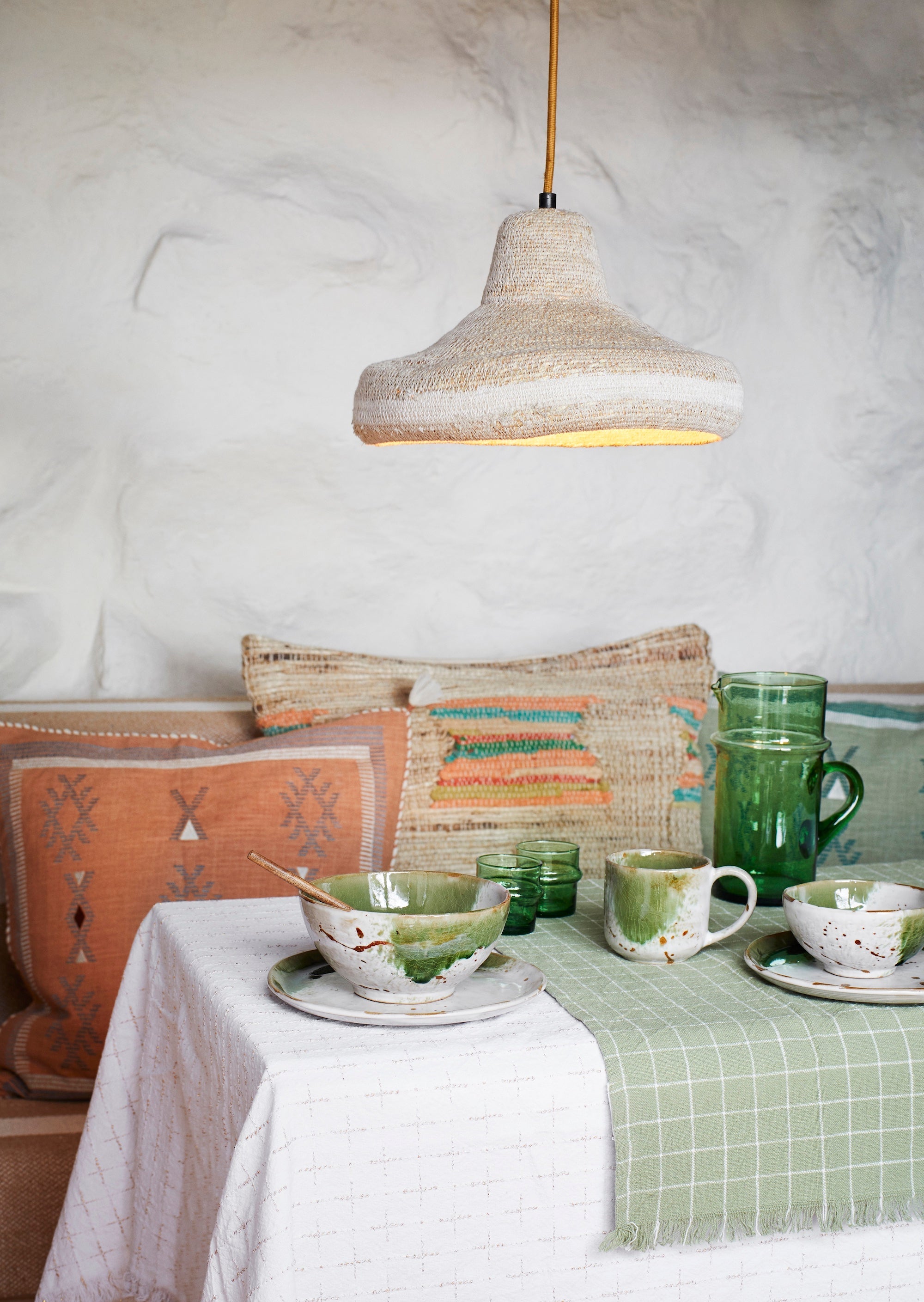 white and green stoneware dinner plate in a Nordic-inspired table setting
