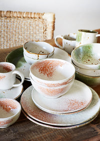 white and green stoneware mug in a relaxed Nordic breakfast table setting
