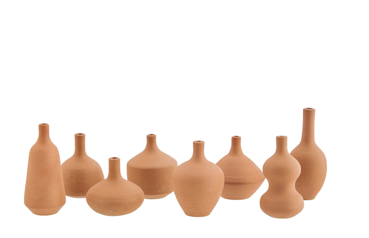 Set of small terracotta vase style incense holders on a white background