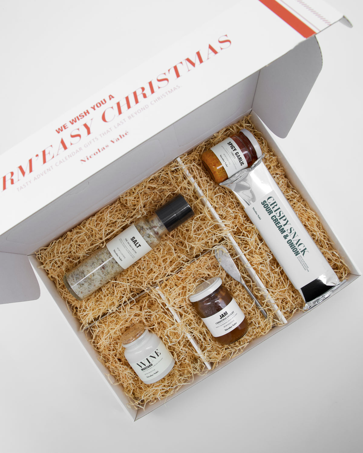 Inside the Nicolas Vahé Advent gift box: salt grinder, spicy garlic, red wine mustard, jam, crisps and golden butter knife in straw