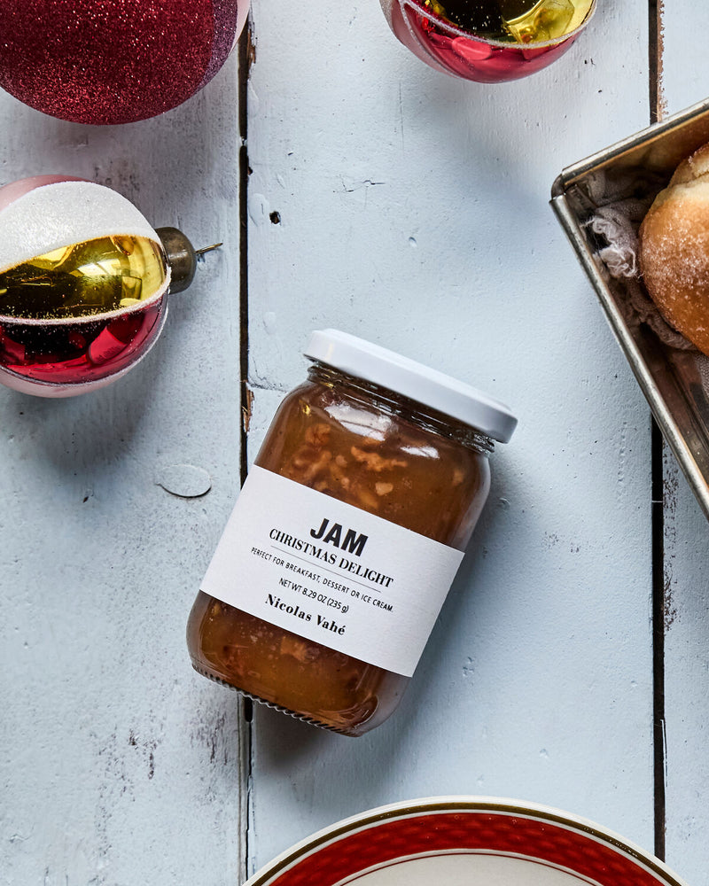 Nicolas Vahé Christmas Delight jam on a pale wooden table with red and gold baubles