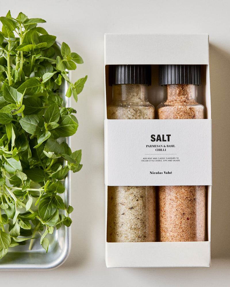 Nicolas Vahé Parmesan and basil and chilli salt gift box beside fresh basil on a metal tray