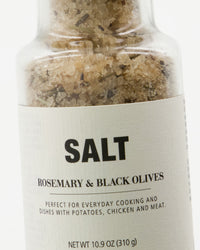 Close-up of the Nicolas Vahé rosemary and black olives salt label and herb-flecked salt