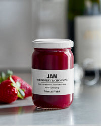 Nicolas Vahé strawberry and champagne jam on a kitchen worktop with fresh strawberries